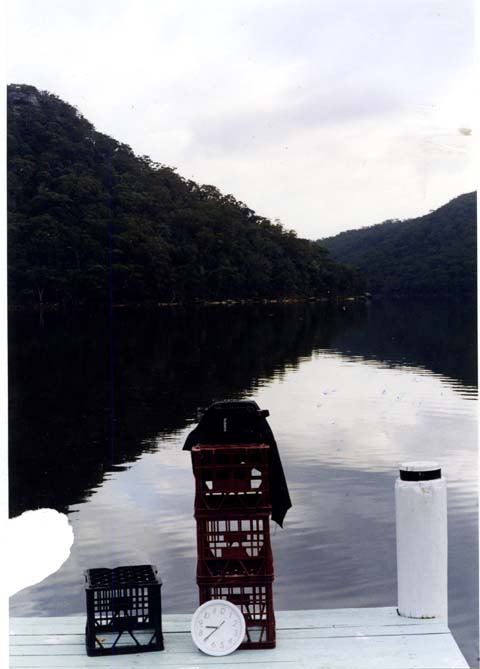 A pinhole camera and clock on a jetty overlooking Woy Woy Bay.