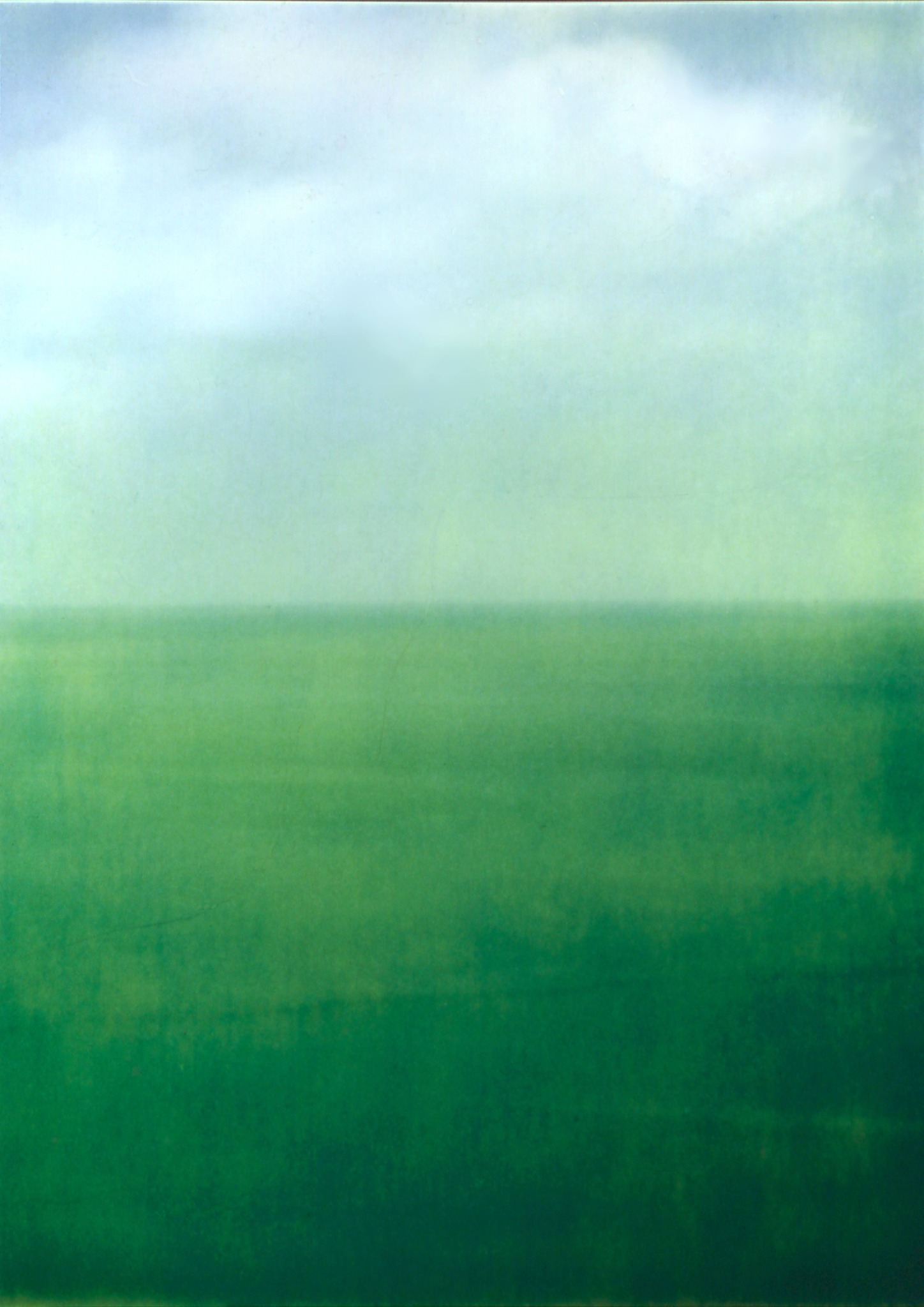 A quiet seascape with a pale sky and deep green water.